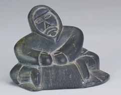 A dark soapstone seated Inuk