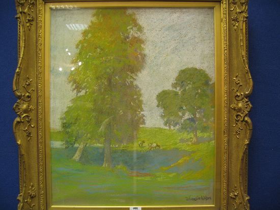 Cattle grazing by trees