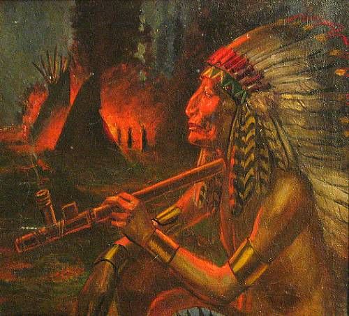 Indian smoking near the campfire