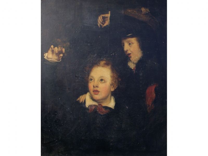 Two boys playing with a bird