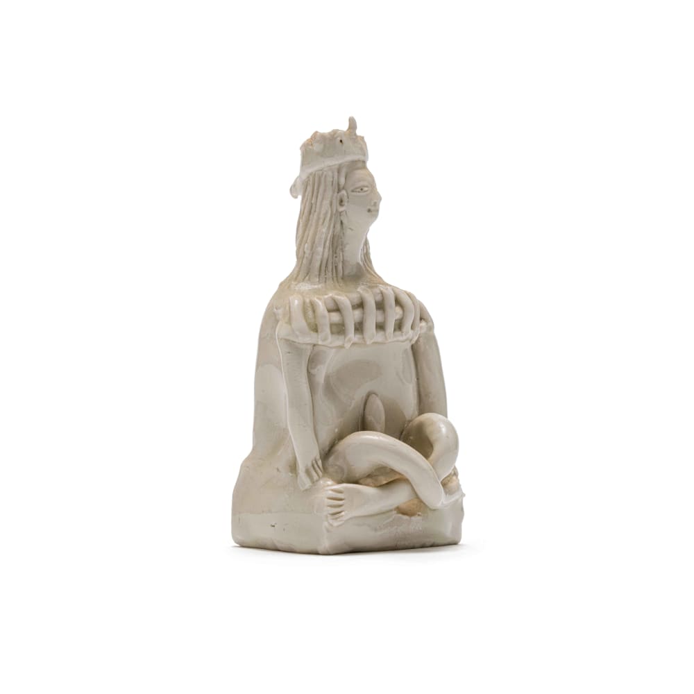 Cross-legged nude figure wearing a hat